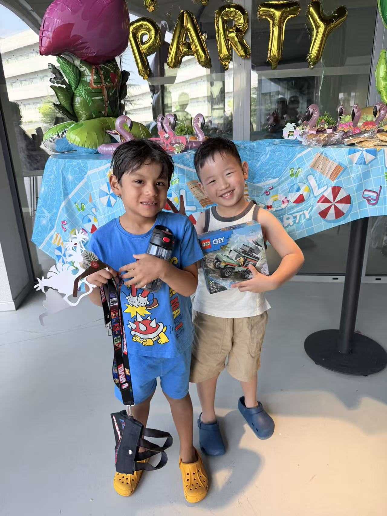Two young friends smiling together at a celebration